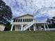 Stately home with screened porch, exterior stairs, and inviting curb appeal at 134 Mohican Dr., Georgetown, SC 29440
