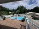 Elevated view of a fenced pool with deck, lounge chairs, and landscaped surroundings at 134 Mohican Dr., Georgetown, SC 29440