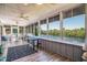 Bright sunroom featuring large windows with serene views of the water at 134 Mohican Dr., Georgetown, SC 29440