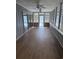 Relaxing sunroom with lots of natural light featuring hardwood floors and wood paneling at 134 Mohican Dr., Georgetown, SC 29440