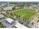 Scenic aerial view of a community with sports fields, a lake, and nearby commercial area at 1379 Cottage Dr., Myrtle Beach, SC 29577