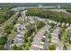 Beautiful aerial view of a residential community featuring mature trees, a pool, and a pond at 1379 Cottage Dr., Myrtle Beach, SC 29577