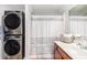 Bathroom featuring a stacked washer/dryer, sink with vanity, and shower with gray and white curtain at 1379 Cottage Dr., Myrtle Beach, SC 29577