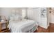 Comfortable bedroom featuring a bed, wood floors, and white closet doors at 1379 Cottage Dr., Myrtle Beach, SC 29577