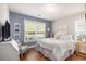Cozy bedroom with natural light, accentuated by a textured wall and crisp white bedding at 1379 Cottage Dr., Myrtle Beach, SC 29577
