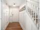 Bright entryway with hardwood floors, fresh paint and a staircase with white railings at 1379 Cottage Dr., Myrtle Beach, SC 29577