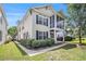 Exterior view of a two-story home featuring a screened porch and well-kept landscaping at 1379 Cottage Dr., Myrtle Beach, SC 29577