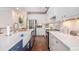 Galley kitchen featuring stainless steel appliances, white cabinets, and countertops with stylish fixtures and decor at 1379 Cottage Dr., Myrtle Beach, SC 29577