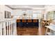 Modern kitchen with white cabinets, stainless steel appliances, and a blue island with bar seating at 1379 Cottage Dr., Myrtle Beach, SC 29577