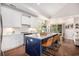 Bright kitchen features white cabinets, marble countertops, herringbone backsplash, and a central island with seating at 1379 Cottage Dr., Myrtle Beach, SC 29577