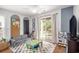Bright playroom featuring a ceiling fan, sofa, play kitchen, and a sliding glass door to the outdoors at 1379 Cottage Dr., Myrtle Beach, SC 29577