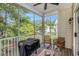 Screened porch with ceiling fan, wooden furniture, and a view of the backyard at 1379 Cottage Dr., Myrtle Beach, SC 29577