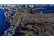 Aerial view of a marsh with a complex of condominiums and single-Gathering homes in the background at 14290 Ocean Hwy. # 312, Pawleys Island, SC 29585