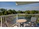 Balcony seating provides views of the neighborhood pond surrounded by trees at 14290 Ocean Hwy. # 312, Pawleys Island, SC 29585