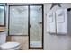 Elegant bathroom featuring a walk-in shower, toilet, and towel rack with white towels at 14290 Ocean Hwy. # 312, Pawleys Island, SC 29585