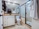 Clean bathroom with tile floors, spacious walk-in shower, and decorative mirror at 14290 Ocean Hwy. # 312, Pawleys Island, SC 29585