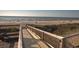 Wooden boardwalk leading to the beach with scenic ocean views and a picnic table at 14290 Ocean Hwy. # 312, Pawleys Island, SC 29585