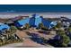 Inviting clubhouse with a blue roof, palm trees, outdoor seating, beach access, and lush landscaping at 14290 Ocean Hwy. # 312, Pawleys Island, SC 29585
