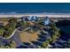 Aerial view of oceanfront clubhouse, showcasing landscaped entrance, nearby beach access, and ample parking at 14290 Ocean Hwy. # 312, Pawleys Island, SC 29585