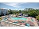 An elevated shot of the large community pool, multiple lounge chairs and an adjacent building at 14290 Ocean Hwy. # 312, Pawleys Island, SC 29585