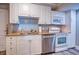 Updated kitchen features stainless appliances, granite counters, and white cabinetry at 14290 Ocean Hwy. # 312, Pawleys Island, SC 29585