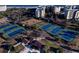 Aerial view of community tennis courts and pavilion, showcasing the lush landscaping, surrounding buildings, and parking at 14290 Ocean Hwy. # 312, Pawleys Island, SC 29585