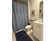 Cozy half bathroom features a sunflower theme, with vanity, toilet, and a decorative shower curtain at 1565 Jardine Loop, Little River, SC 29566