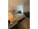 Cozy bedroom with a patterned bedspread, soft lighting, and neutral wall colors at 1565 Jardine Loop, Little River, SC 29566