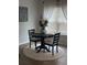 Bright breakfast nook featuring a round table, seating for two, and decorative floral centerpiece at 1565 Jardine Loop, Little River, SC 29566