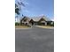 Beautiful stone clubhouse with peaked roof and well-maintained landscaping at 1565 Jardine Loop, Little River, SC 29566