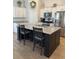 Spacious kitchen featuring a large center island with bar seating, stainless steel appliances, and ample cabinet space at 1565 Jardine Loop, Little River, SC 29566