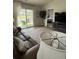 Comfortable living room featuring a large sofa, area rug, and access to a private outdoor patio at 1565 Jardine Loop, Little River, SC 29566