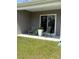 A quaint patio area with chairs, a small table, and a potted fern at 1565 Jardine Loop, Little River, SC 29566