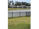 Scenic view of a pond with a black fence, surrounded by green grass and houses at 1565 Jardine Loop, Little River, SC 29566