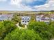 Aerial view of a waterfront property with lush trees surrounding neighboring homes at 172 Colony Point Dr., Georgetown, SC 29440