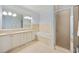 Elegant bathroom with dual sinks, a large soaking tub, marble finishes, and a glass-enclosed shower at 172 Colony Point Dr., Georgetown, SC 29440