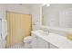 Well-lit bathroom with a marble countertop, a single sink, black and white tiled floors, and a shower with a curtain at 172 Colony Point Dr., Georgetown, SC 29440