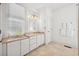 Bright bathroom with dual sinks, marble floors, and an elegant light fixture over the mirror at 172 Colony Point Dr., Georgetown, SC 29440