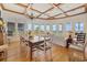 Bright dining room with coffered ceilings, a wooden table and chairs, and abundant natural light from large windows at 172 Colony Point Dr., Georgetown, SC 29440