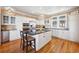 Well-appointed kitchen boasts a center island with seating, modern appliances, and hardwood flooring at 172 Colony Point Dr., Georgetown, SC 29440