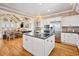 Bright kitchen featuring wood paneled walls, granite countertops, stainless steel appliances, and a center island at 172 Colony Point Dr., Georgetown, SC 29440