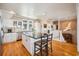 Bright kitchen featuring wood paneled walls, granite countertops, stainless steel appliances, and an island with chairs at 172 Colony Point Dr., Georgetown, SC 29440