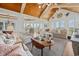 Spacious living room features high, wood-paneled ceilings, large windows, and comfortable seating at 172 Colony Point Dr., Georgetown, SC 29440