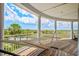 Relaxing covered porch with a hammock, white columns, overlooking the river, marsh, and distant landscape at 172 Colony Point Dr., Georgetown, SC 29440