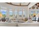 Bright sunroom with large windows and doors leading to a balcony, offering serene views of the marshland at 172 Colony Point Dr., Georgetown, SC 29440