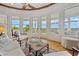 Inviting sunroom with marsh views featuring cozy seating and natural light through large windows at 172 Colony Point Dr., Georgetown, SC 29440