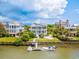 Waterfront view of multiple homes with boats docked along a calm waterway at 172 Colony Point Dr., Georgetown, SC 29440