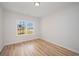 Bedroom featuring wood floors, a large window with neighborhood views, and neutral walls at 178 Six Mile Creek Dr., Georgetown, SC 29440