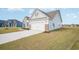 Side view of the home featuring a two-car garage with a paved driveway at 178 Six Mile Creek Dr., Georgetown, SC 29440