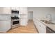 Modern kitchen with stainless steel appliances, tile backsplash, and hardwood floors at 178 Six Mile Creek Dr., Georgetown, SC 29440